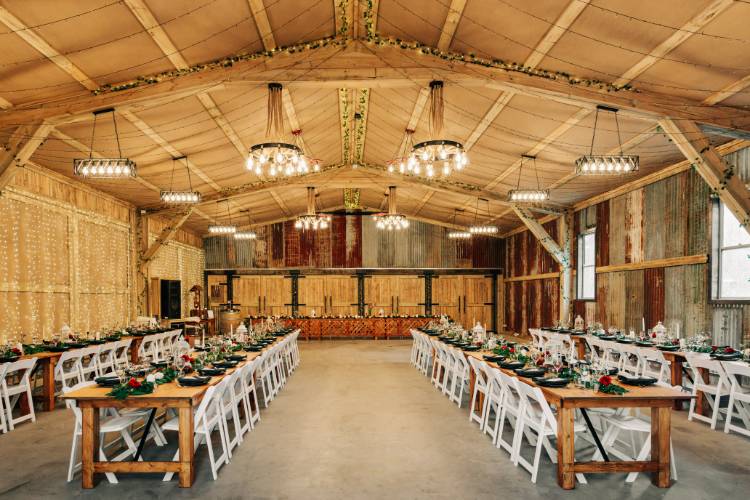 Rustic barn reception venue with fairy lit timber walls