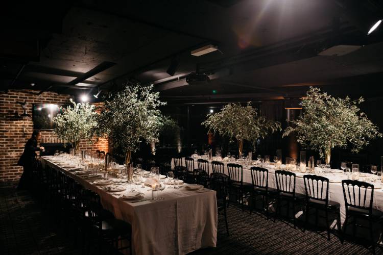 Moody and small reception space with long tables at Jones Bay Wharf Sydney