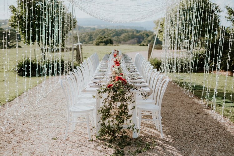 Small outdoor wedding reception with fairy lights at Byron View Estate